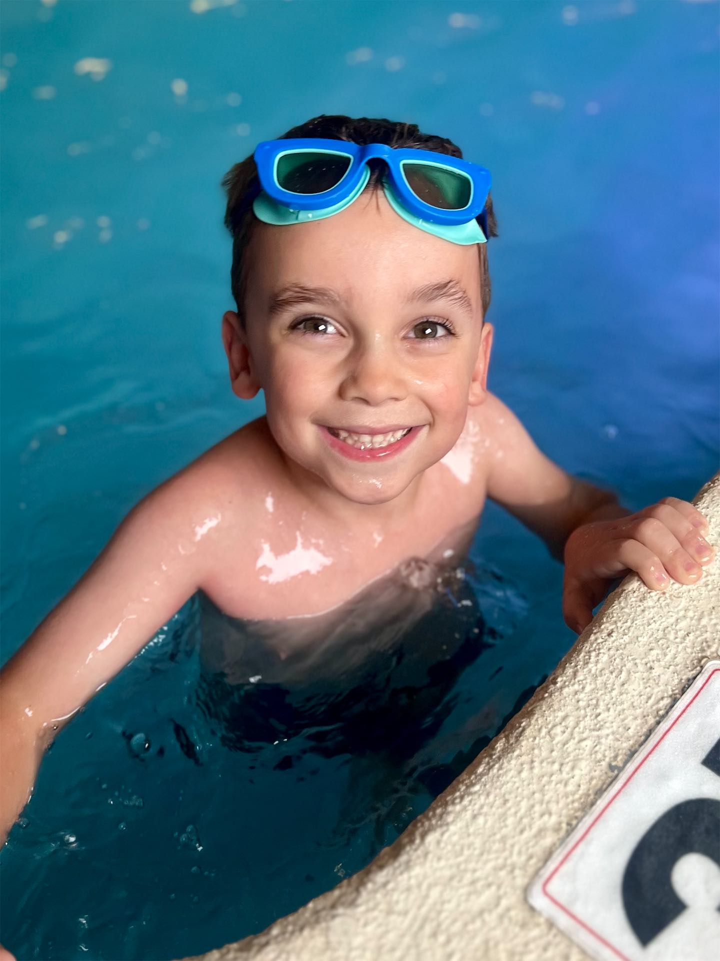 Private swim lesson with a teenage student refining stroke technique