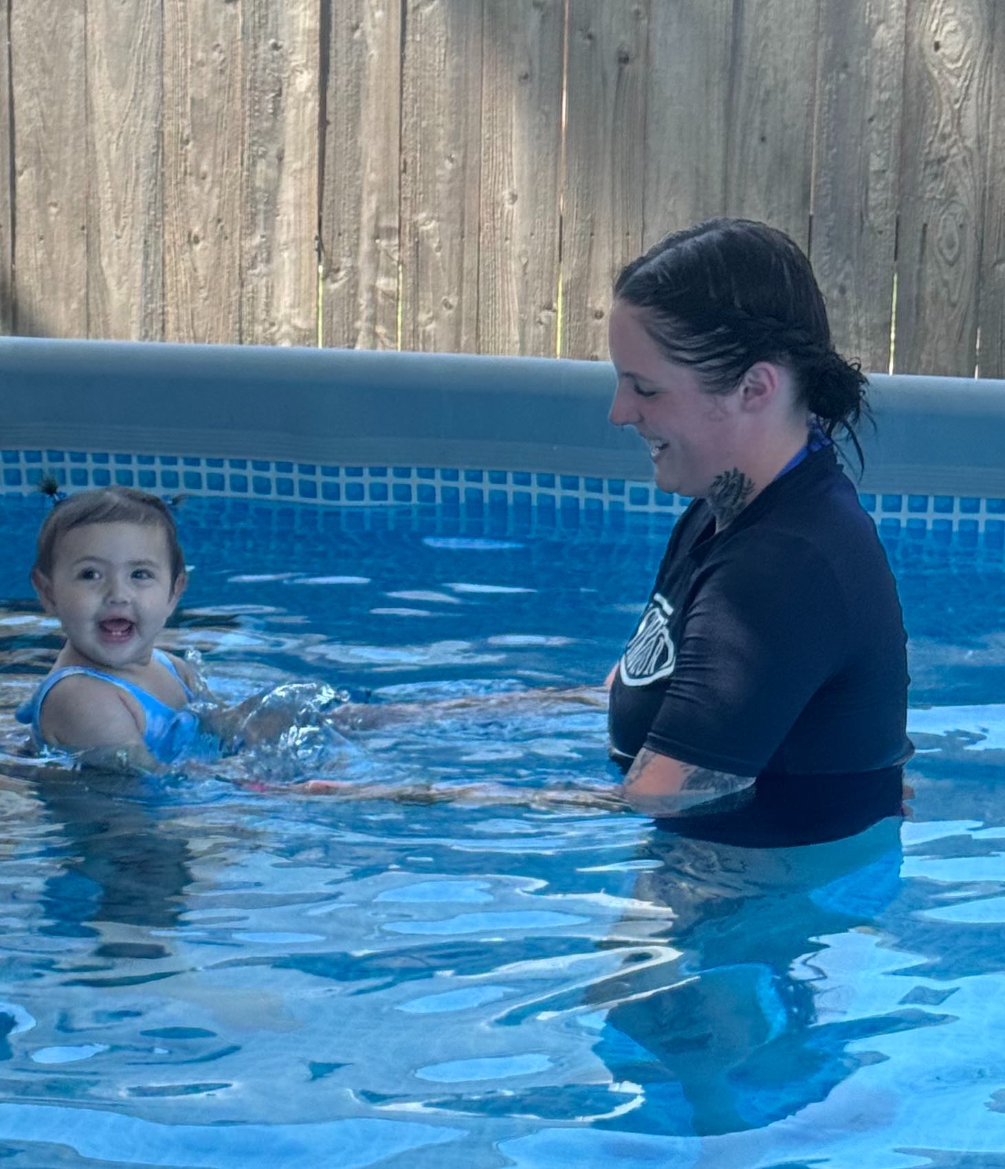 Smiling child after her first successful back-float in OKC
