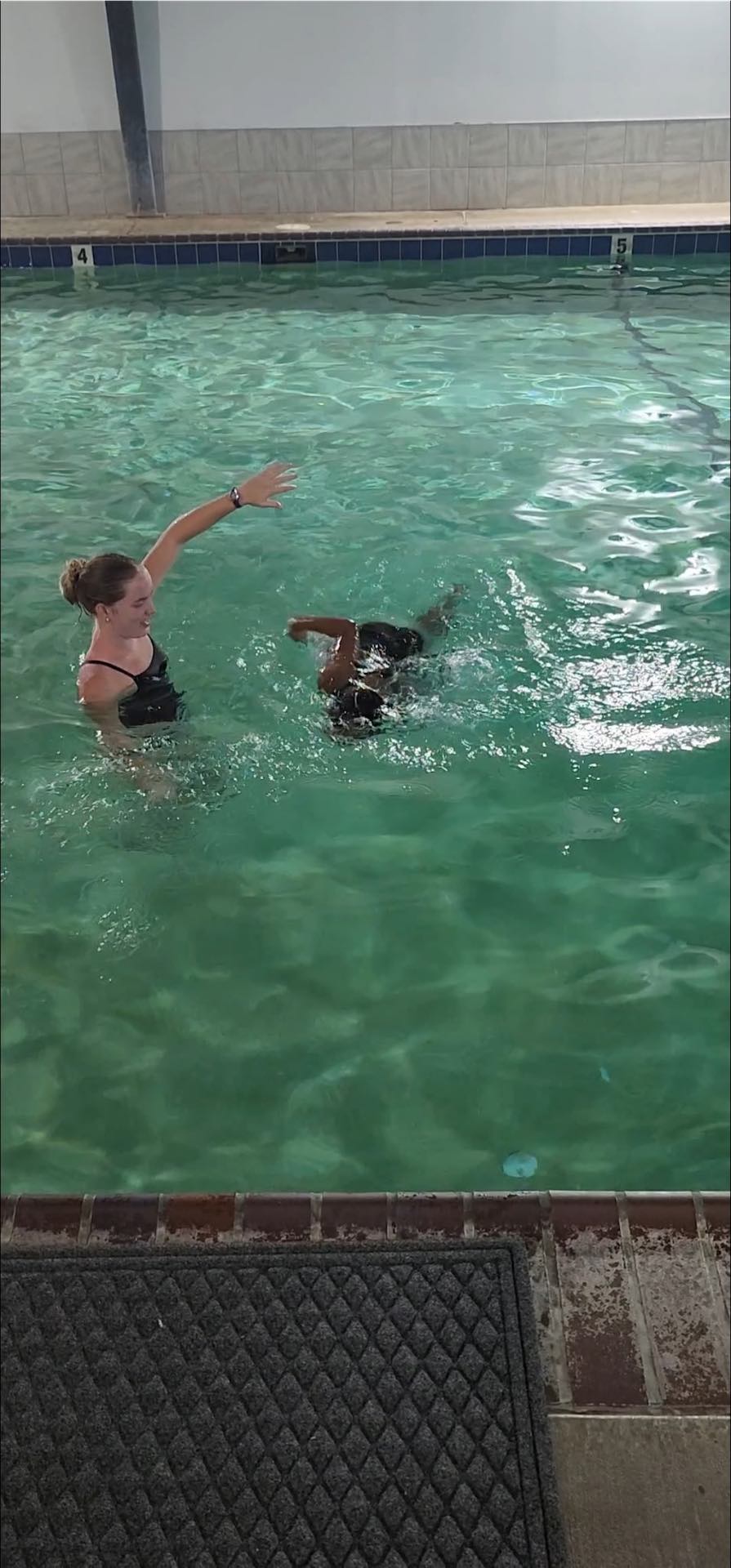 Small group swim class for siblings at an indoor Edmond pool