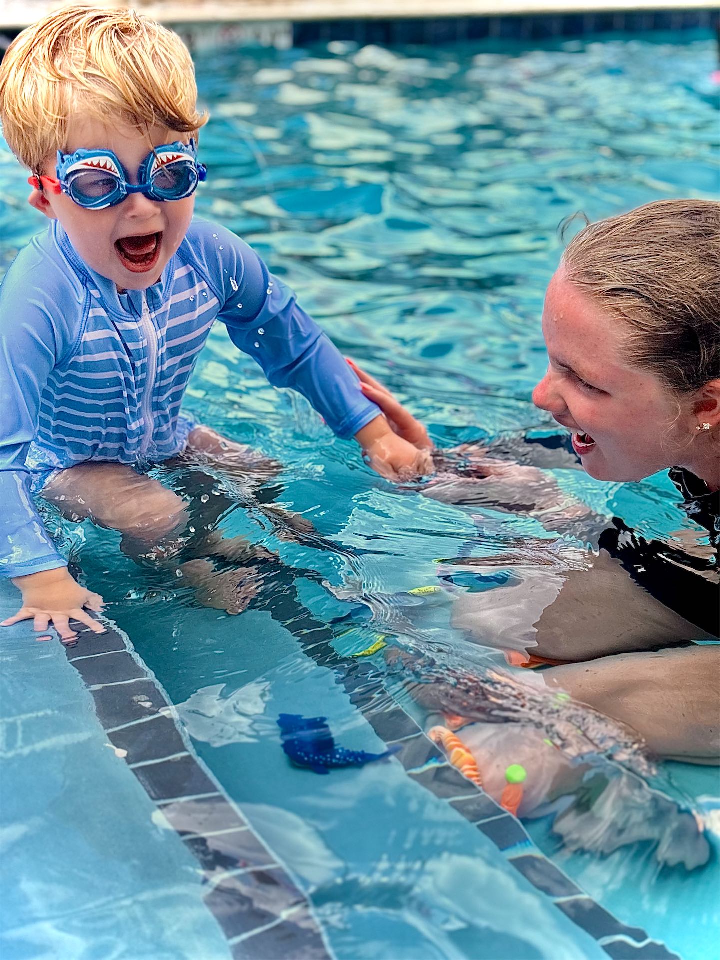 Young boy swimming a full lap for the first time at Like a Fish