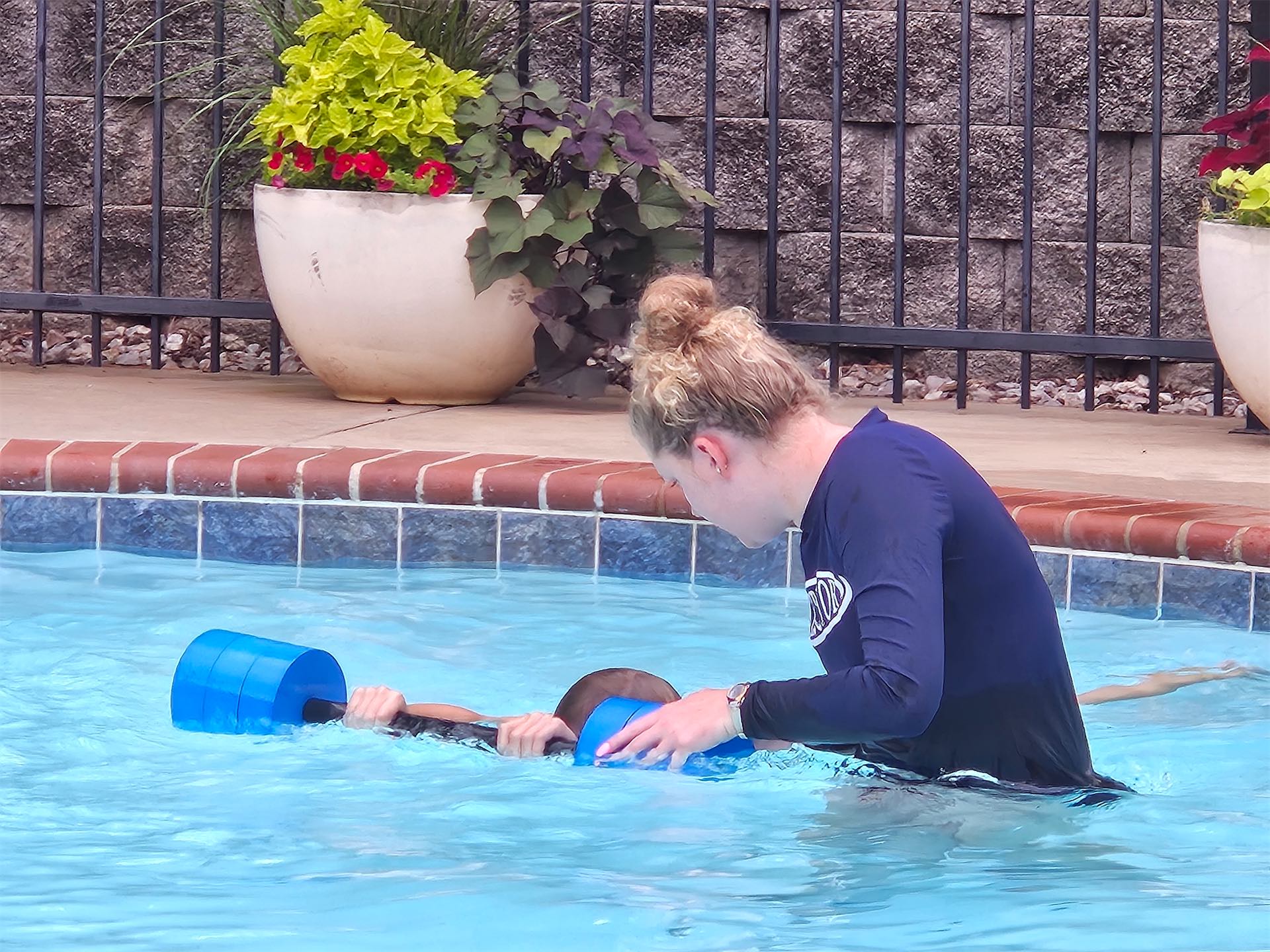 Child learning to dive safely under the guidance of a certified instructor