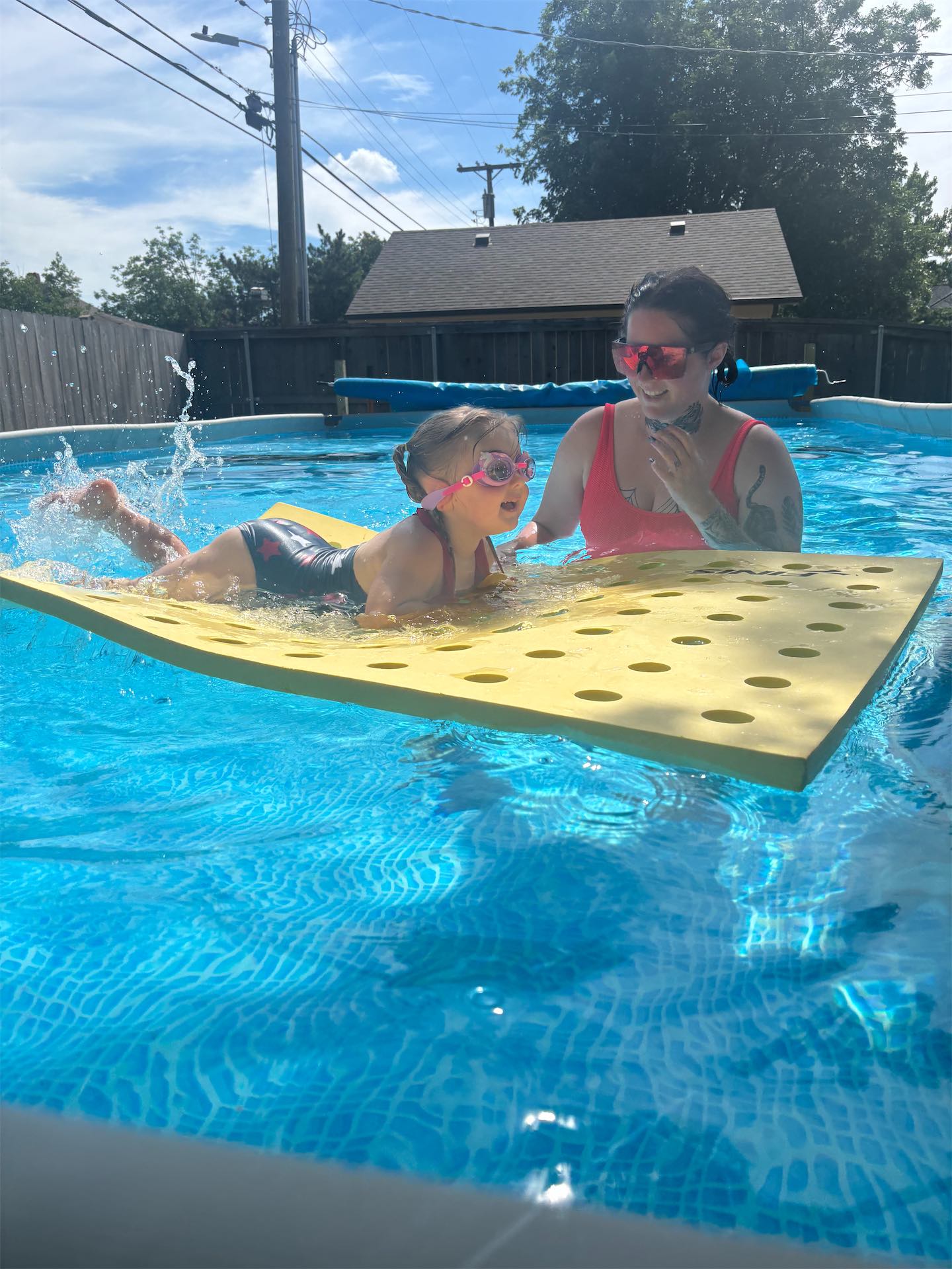 Instructor teaching proper arm entry for freestyle stroke to a youth swimmer