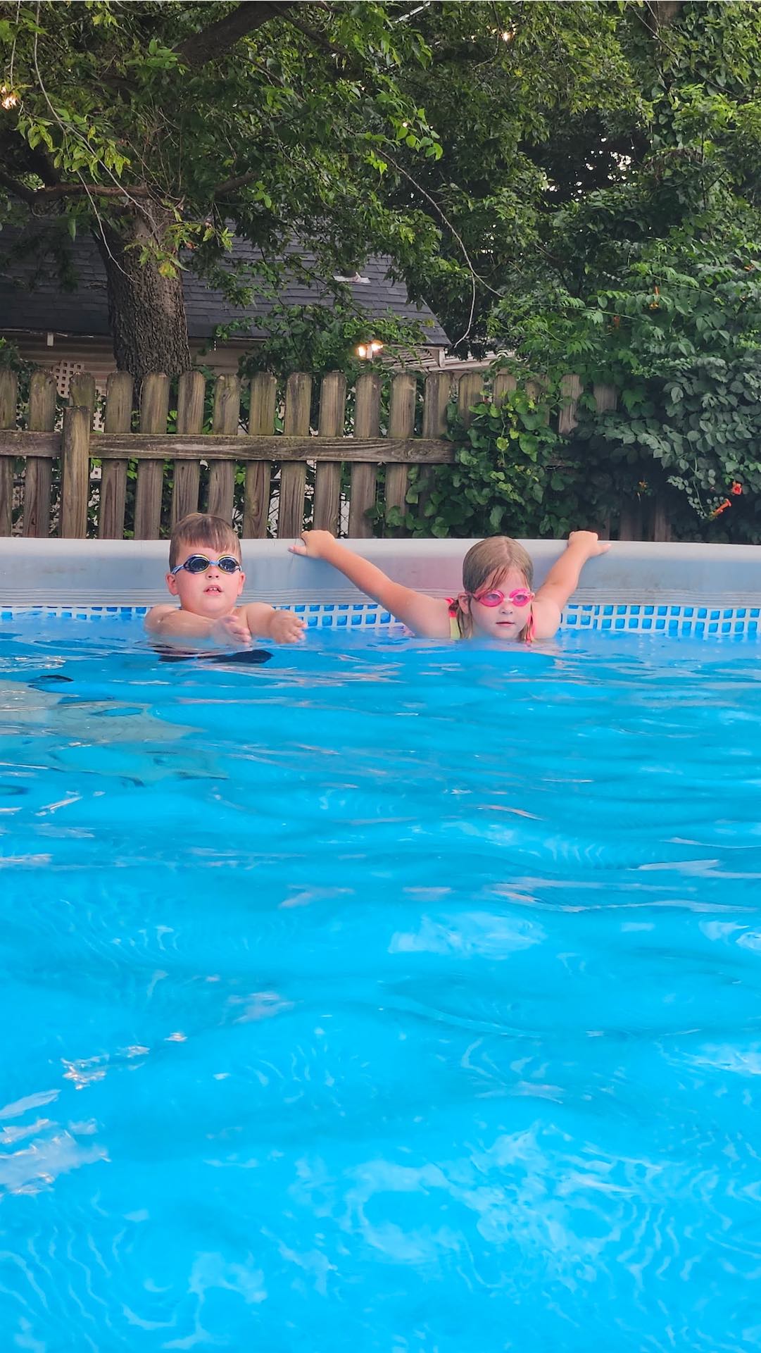 Kids laughing and splashing during a group swim class in Oklahoma City