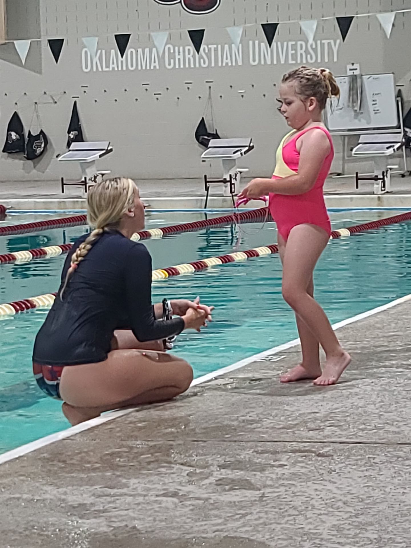 Child completing a water safety drill at an Edmond indoor pool