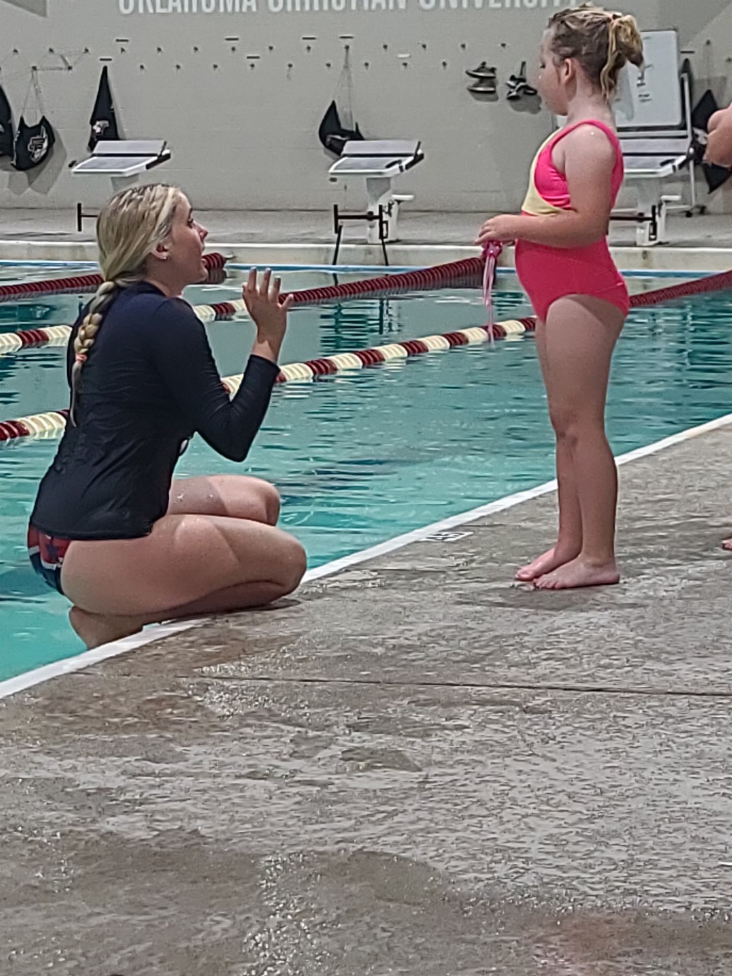 End-of-lesson celebration with a proud young swimmer in OKC