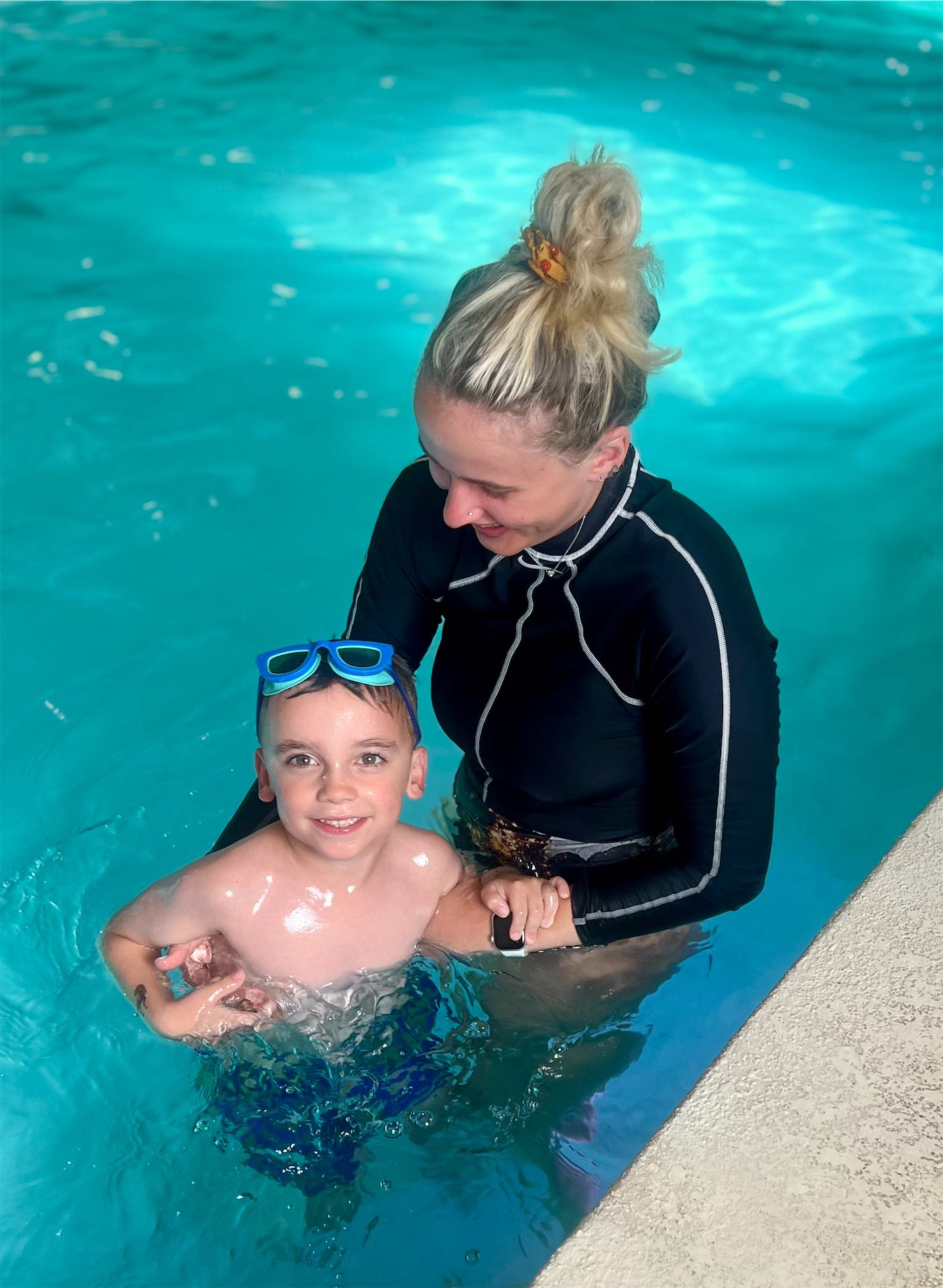 Boy jumping into the pool during a swim lesson in Edmond, Oklahoma